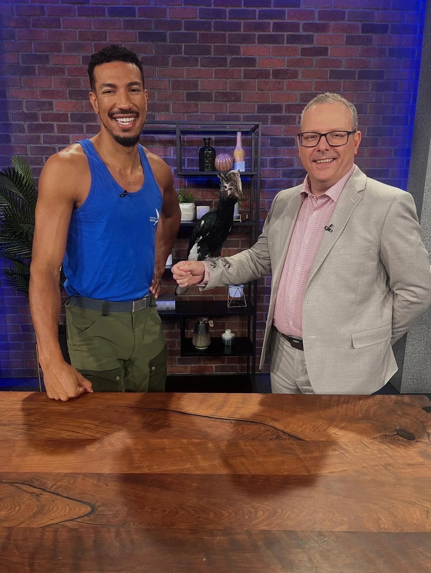 Hands On Exotics handler on a TV studio set introducing an exotic bird to a daytime talk show host